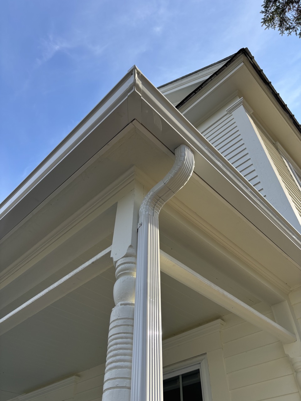 White seamless gutter and downspout on colonial home